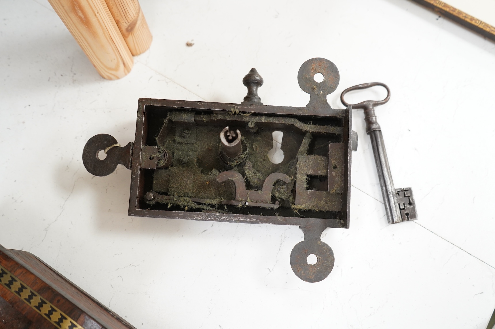 A 17th century steel door lock and key, lock 24cm wide.